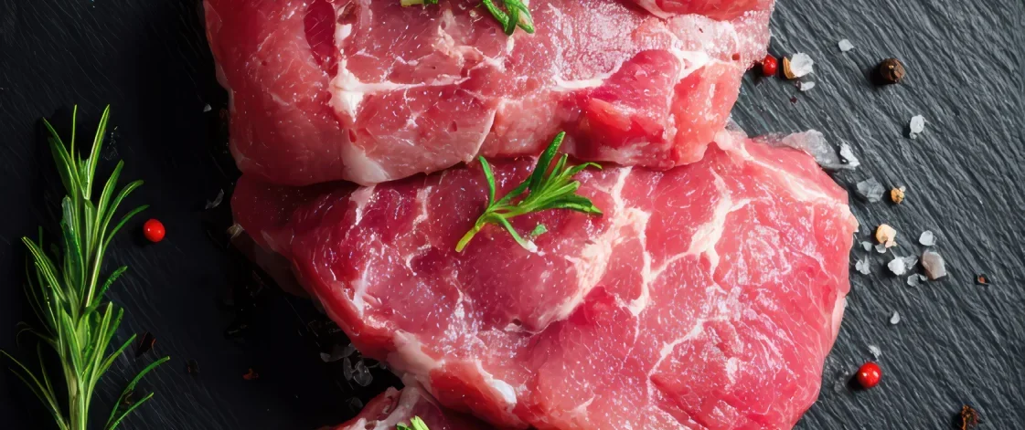 fresh-raw-meat-steaks-with-rosemary-spices-dark-stone